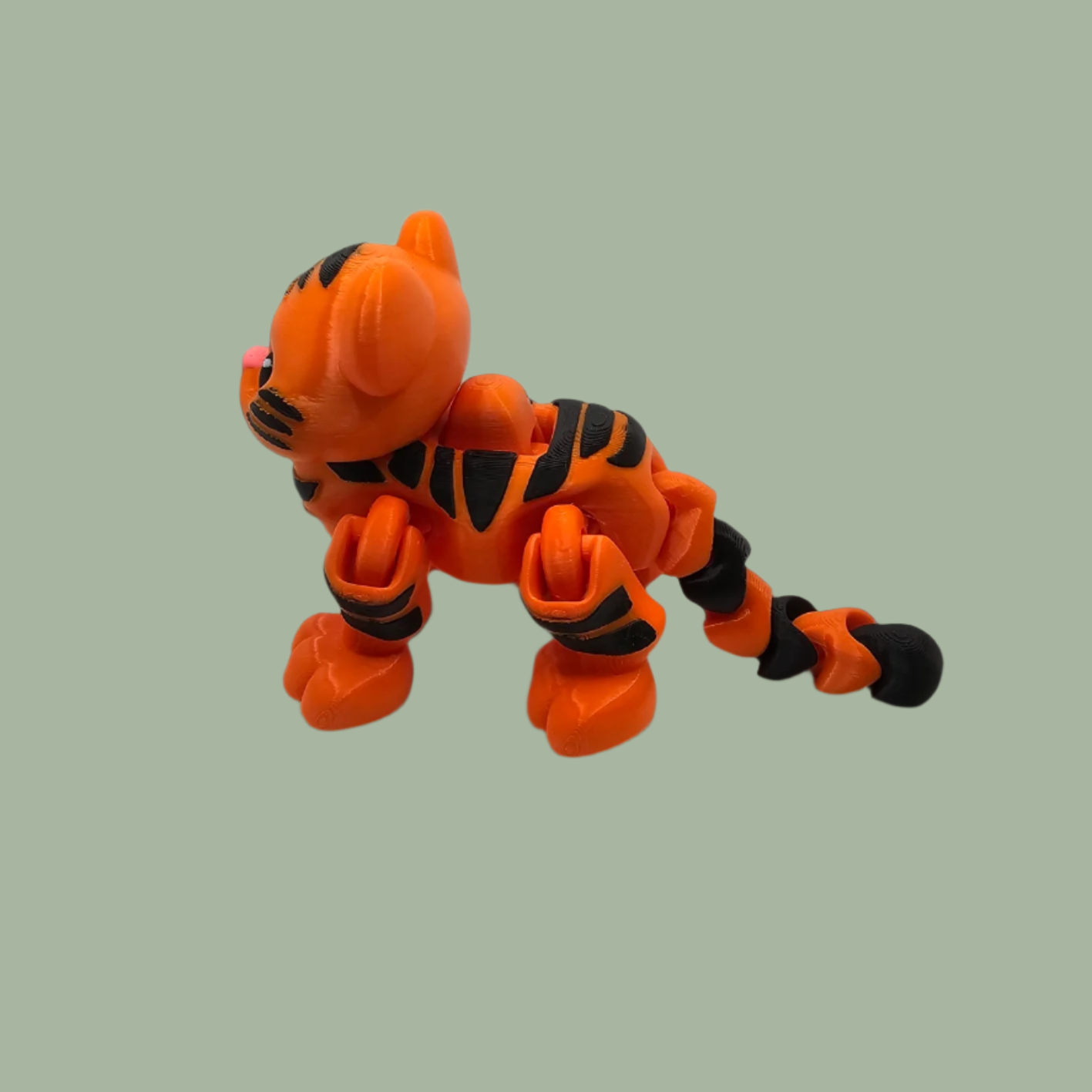 3D printed orange tiger with black stripes, with button mechanism to create a running motion