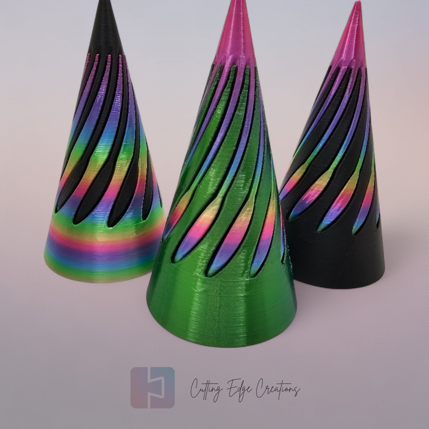 vibrant 3D-printed Infinity Cones V2, each featuring a sleek spiral cut design. The cones are in a random colour, including white, green, black, and rainbow gradients. Designed for smooth sliding and fidgeting, these eye-catching desk toys are handmade in the UK