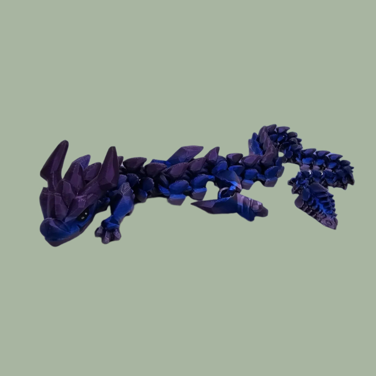 3D printed articulated dragon in a blue/purple colour