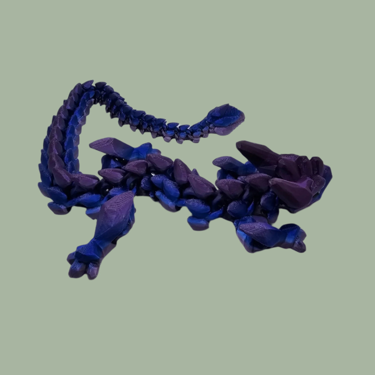 3D printed articulated dragon in a blue/purple colour