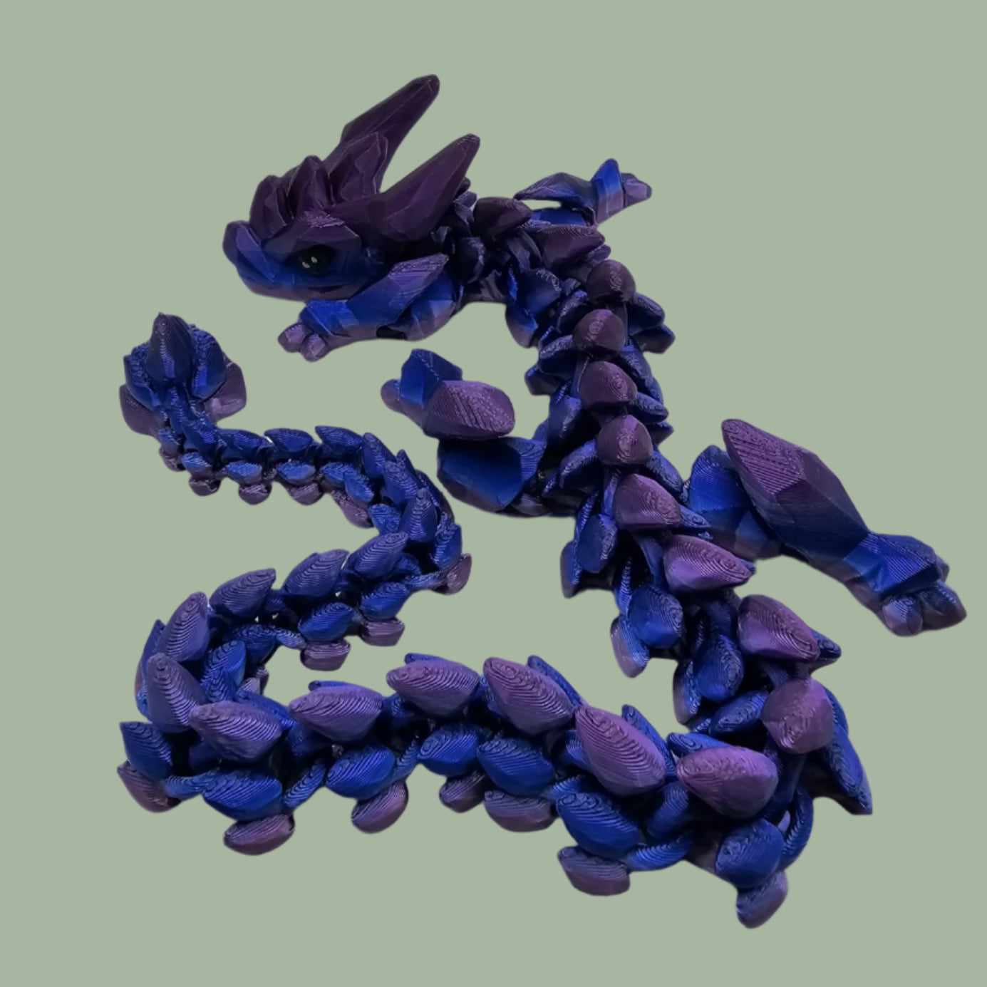 3D printed articulated dragon in a blue/purple colour