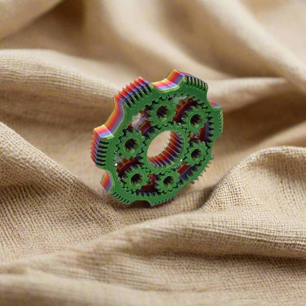 3D printed gear spinner fidget toy in multicolour filament with interlocking moving gears