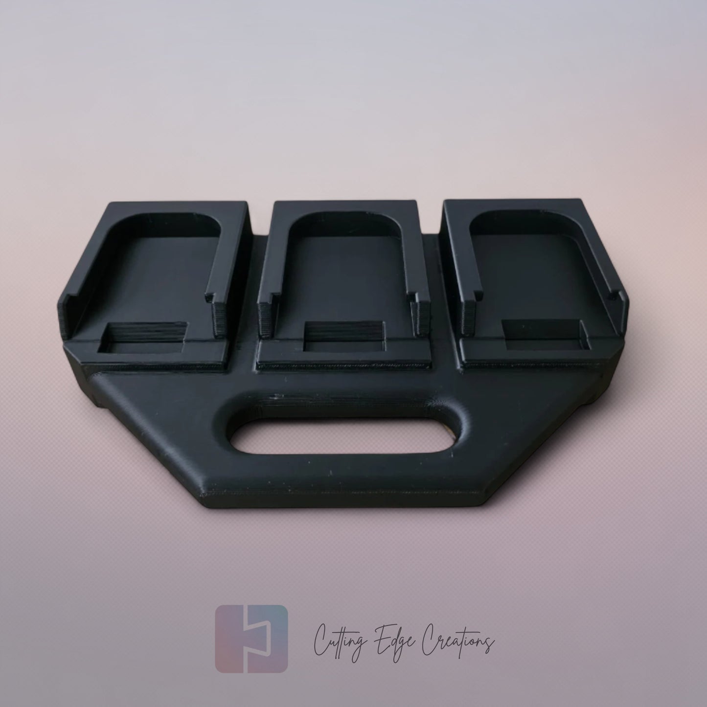 Black 3D printed battery caddy holding six Makita-compatible batteries with built-in carry handle