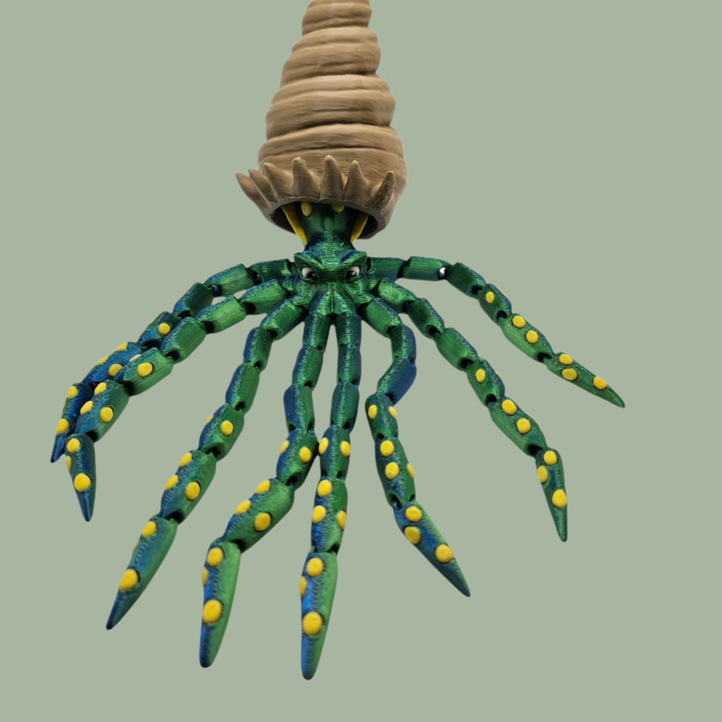 3D printed articulated green octopus with yellow spots and removeable shell hat