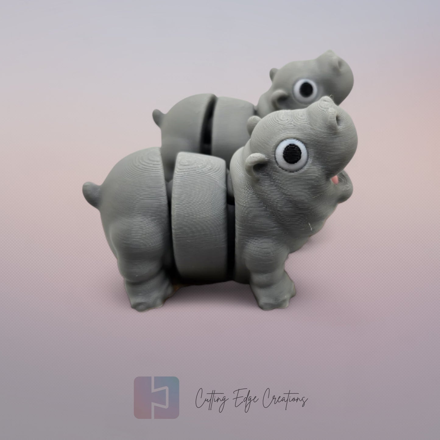 Pair of 3D printed happy flexi baby hippos, one with a pink throat/neck