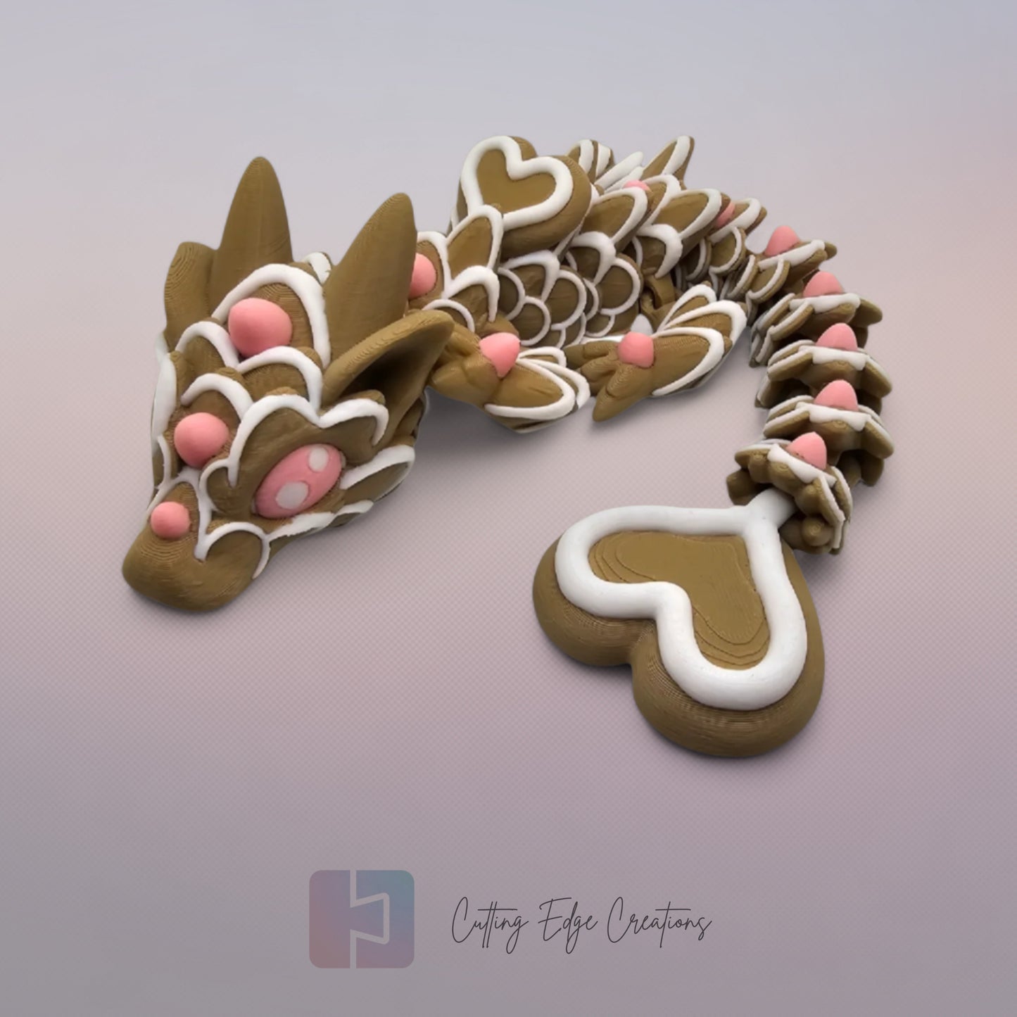 3D printed cookie style articulated dragon with pink and white icing details