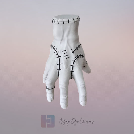 Close-up of white 3D printed stitched hand model, creepy Addams Family style ornament