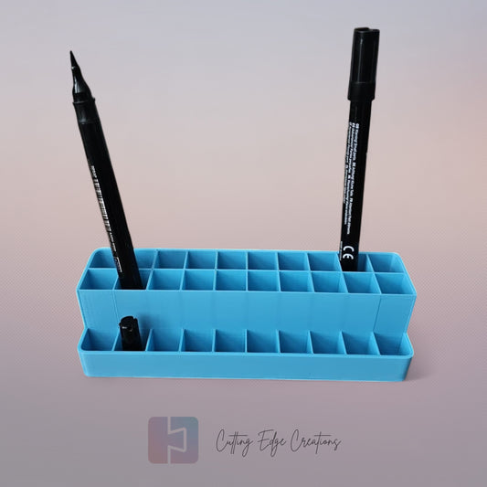3D printed blending marker and pen stand holding colourful markers and lids on a tidy artist’s desk