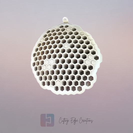 A 3D printed fake wasp nest with a honeycomb pattern, mounted under a wooden shed roof to deter real wasps.