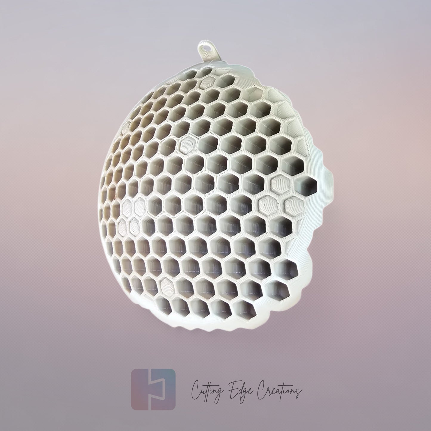 A 3D printed fake wasp nest with a honeycomb pattern, mounted under a wooden shed roof to deter real wasps.