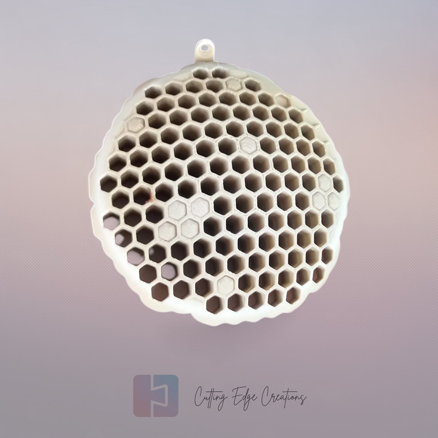 A 3D printed fake wasp nest with a honeycomb pattern, mounted under a wooden shed roof to deter real wasps.