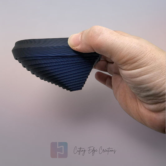 Cutting Edge Creations interlocking flexi heart fidget toy, 3D printed in dark blue bio-filament.