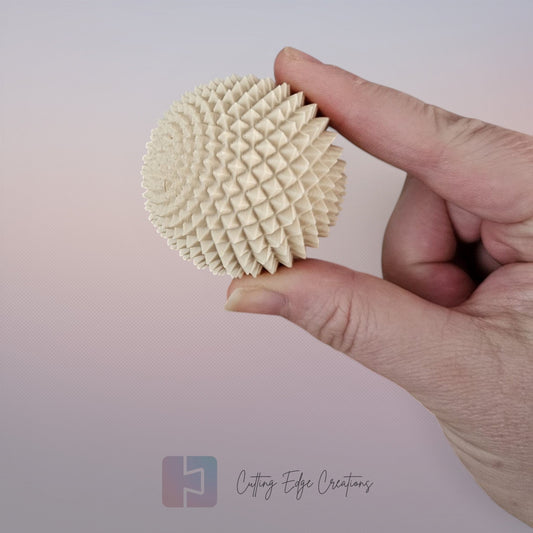 Cutting Edge Creations palm-sized beige textured spike sphere fidget toy made of 3D printed polymer.