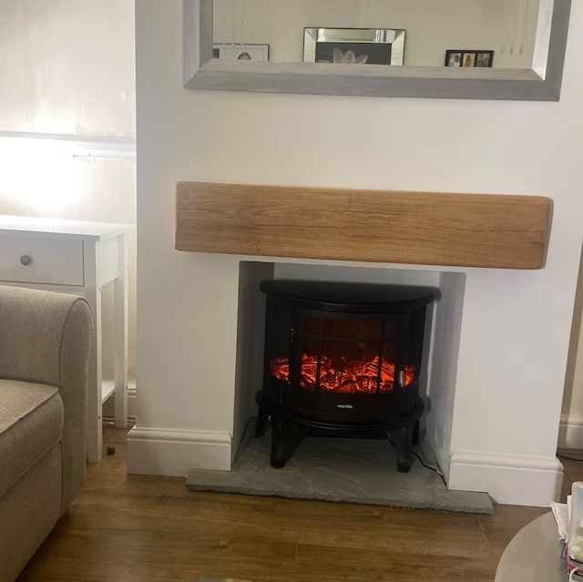 Handmade rustic oak beam mantel mounted on wall with concealed fixings
