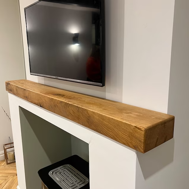 Handmade rustic oak beam mantel mounted on wall with concealed fixings
