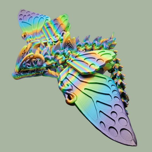 3D printed articulated butterfly dragon with wings in a rainbow colour