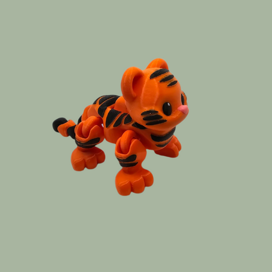 3D printed orange tiger with black stripes, with button mechanism to create a running motion