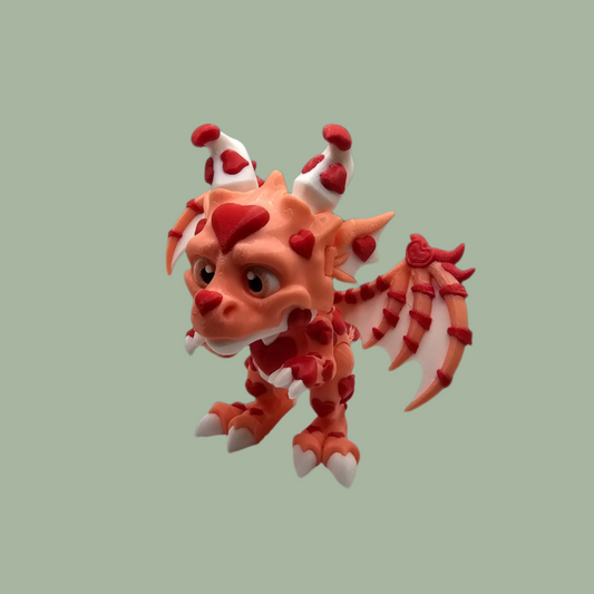 3D printed dragon figurine with fixed wings with pink body and red heart details
