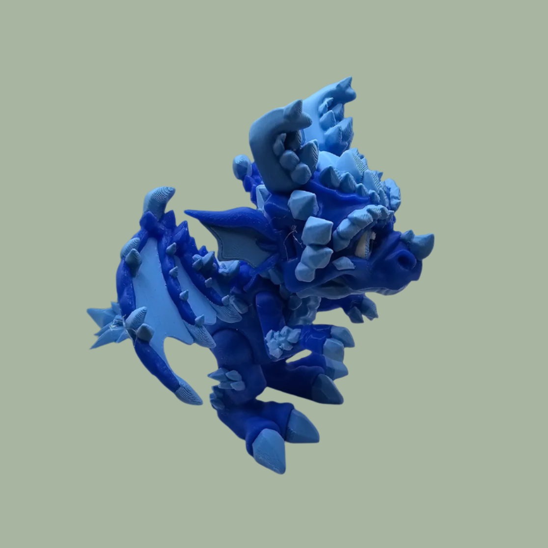 3D printed dragon figurine with fixed wings with light and dark blue ice crystal details