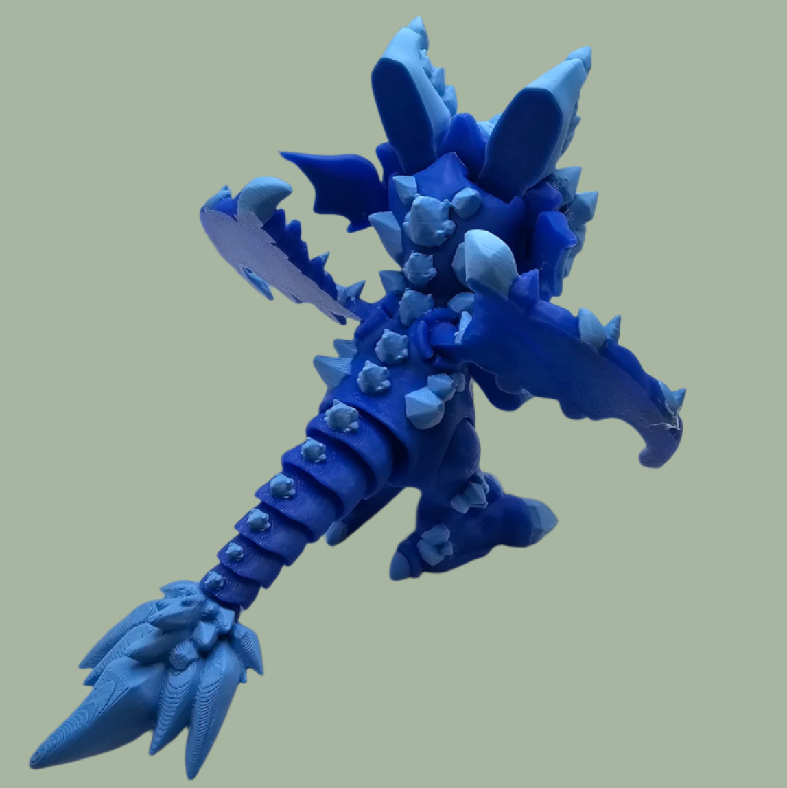 3D printed dragon figurine with fixed wings with light and dark blue ice crystal details