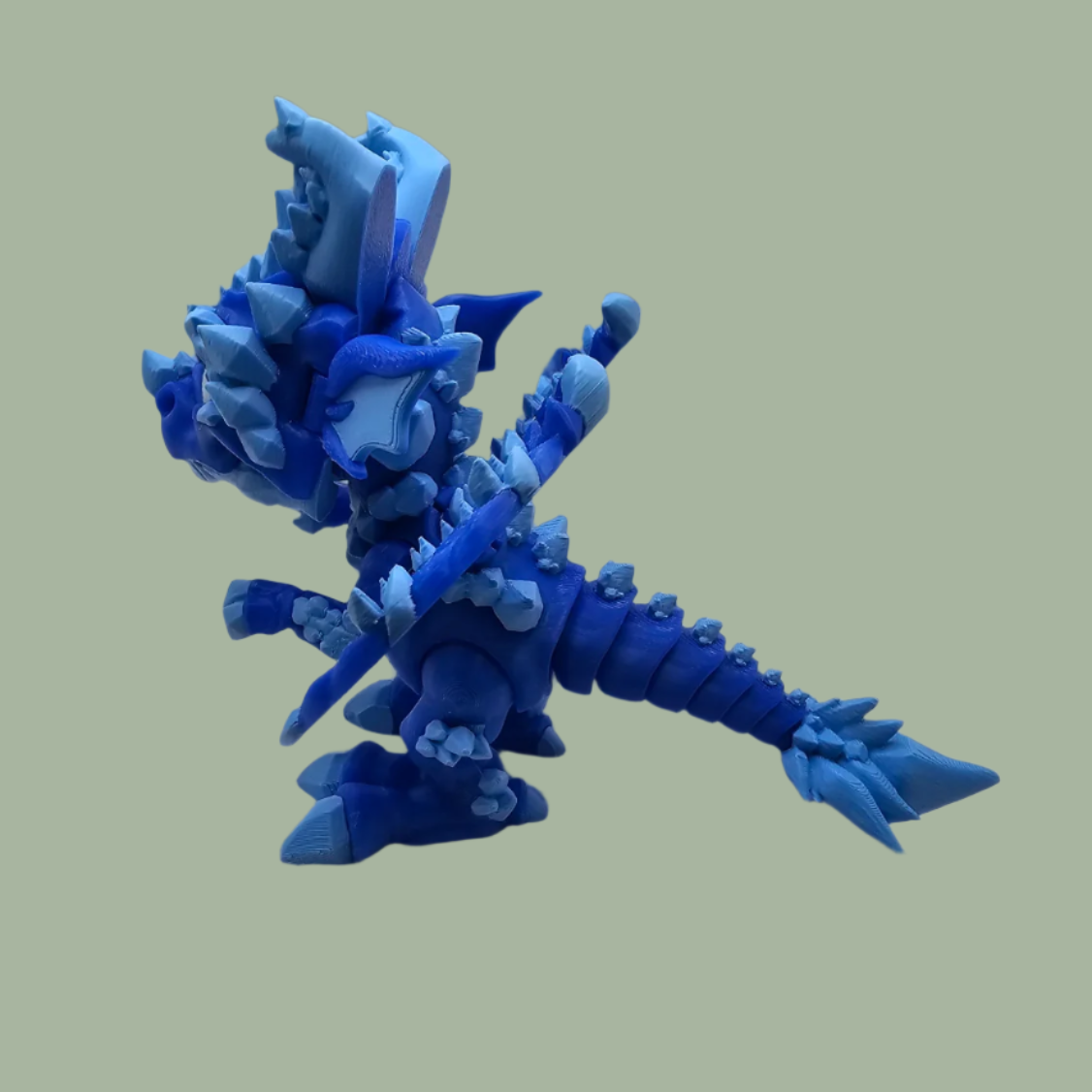 3D printed dragon figurine with fixed wings with light and dark blue ice crystal details