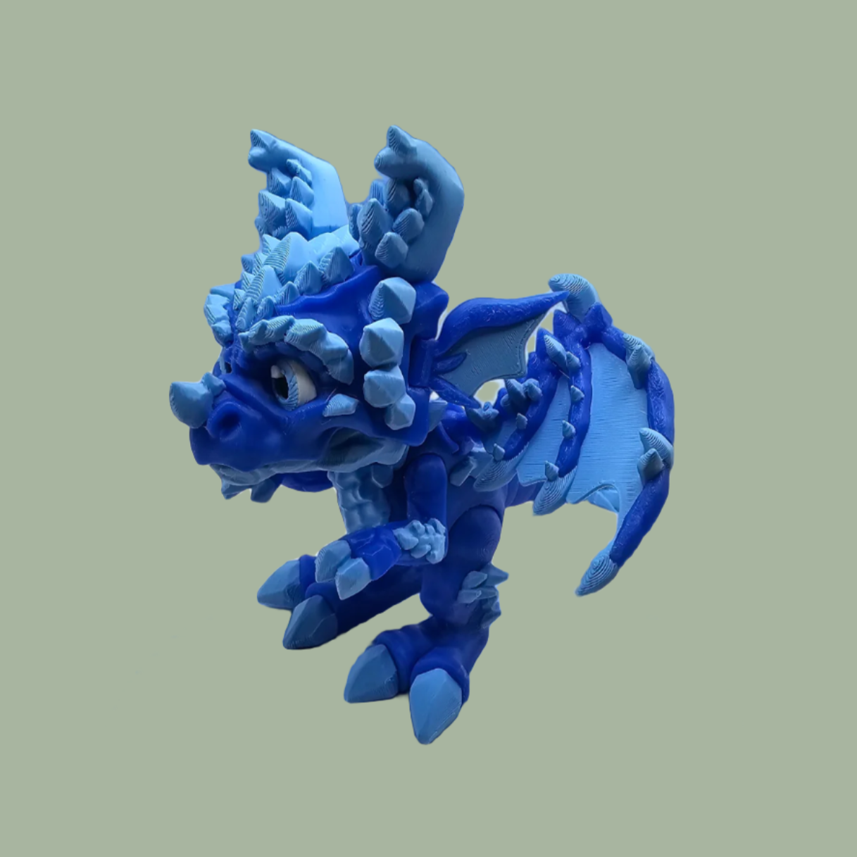 3D printed dragon figurine with fixed wings with light and dark blue ice crystal details