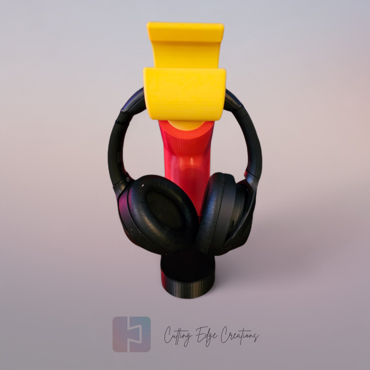 3D printed block style arm in various colours, with black base for wall or freestanding mounting, with chunky yellow hand to hold headphones or coats