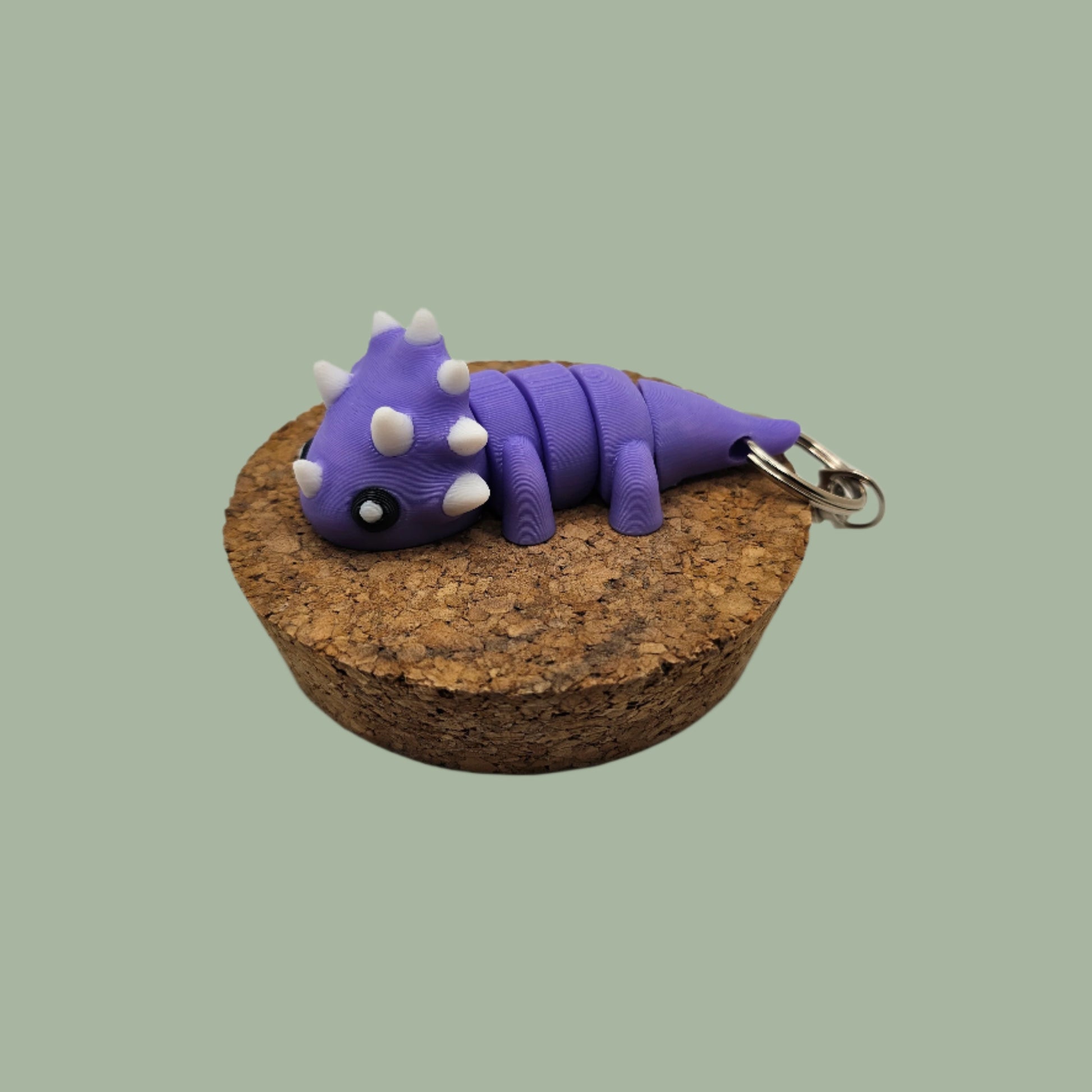 3D printed articulated purple and white dinosaur keyring