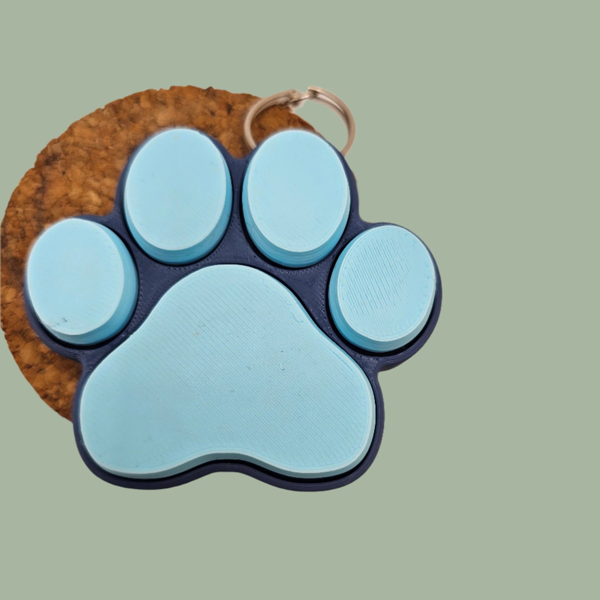 3D printed cat paw with 5 clickable buttons in a random pastel colour