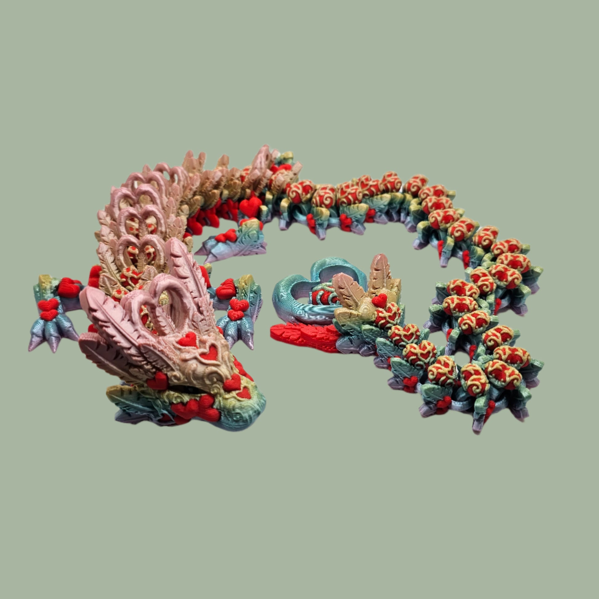 3D printed articulated dragon with heart details along the body and a spinning heart in the tail