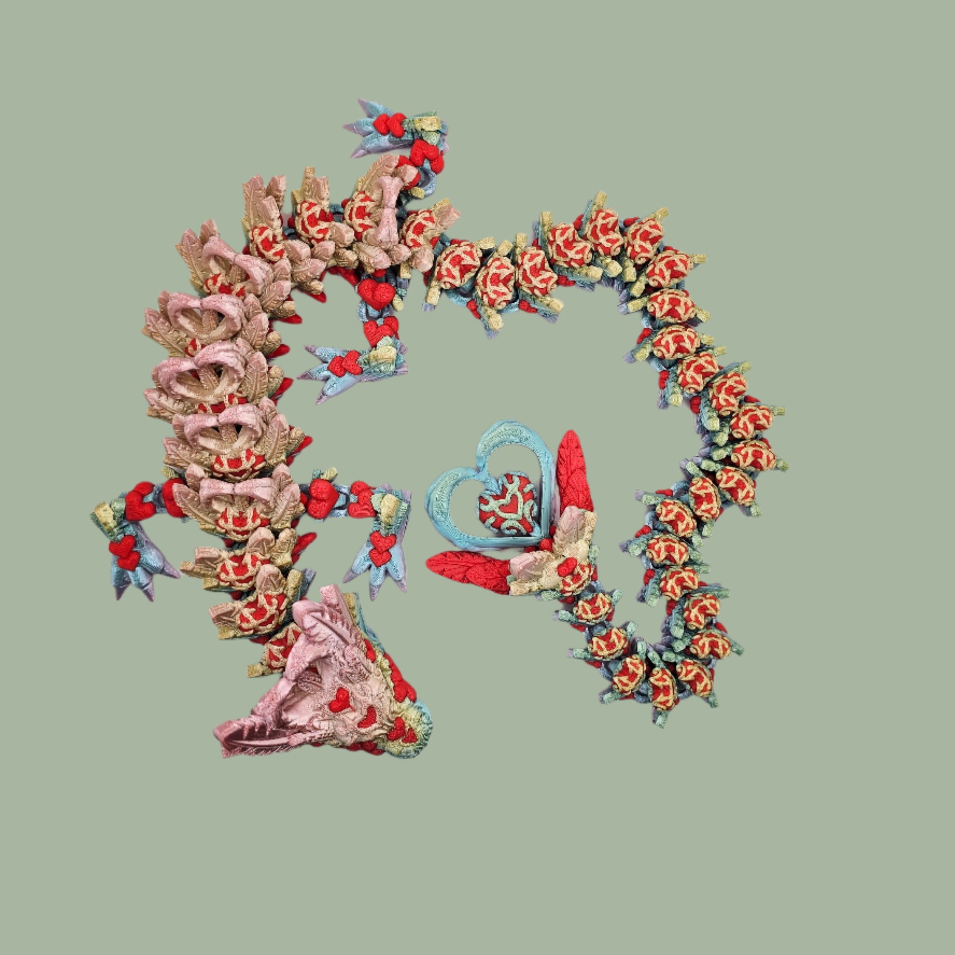 3D printed articulated dragon with heart details along the body and a spinning heart in the tail