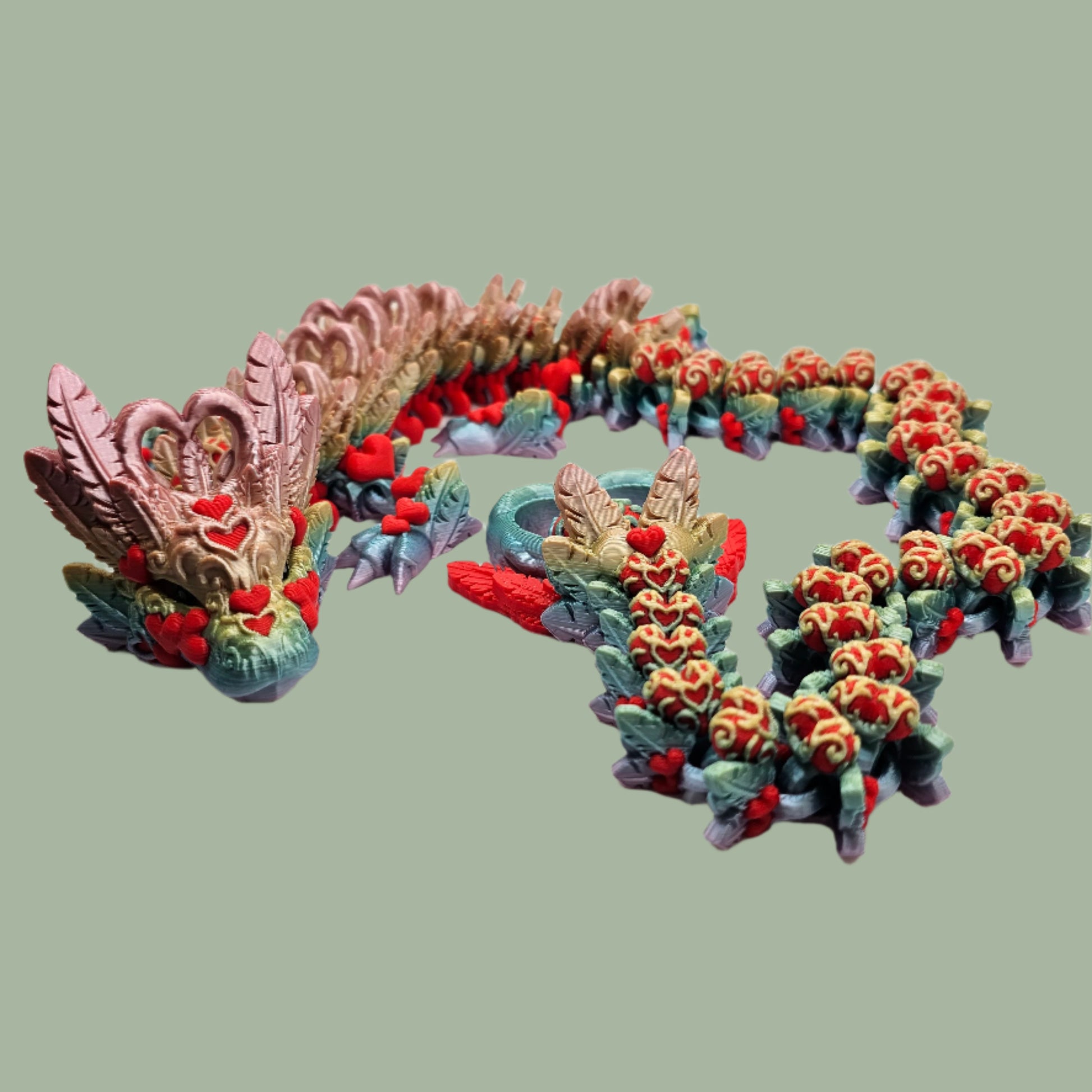 3D printed articulated dragon with heart details along the body and a spinning heart in the tail