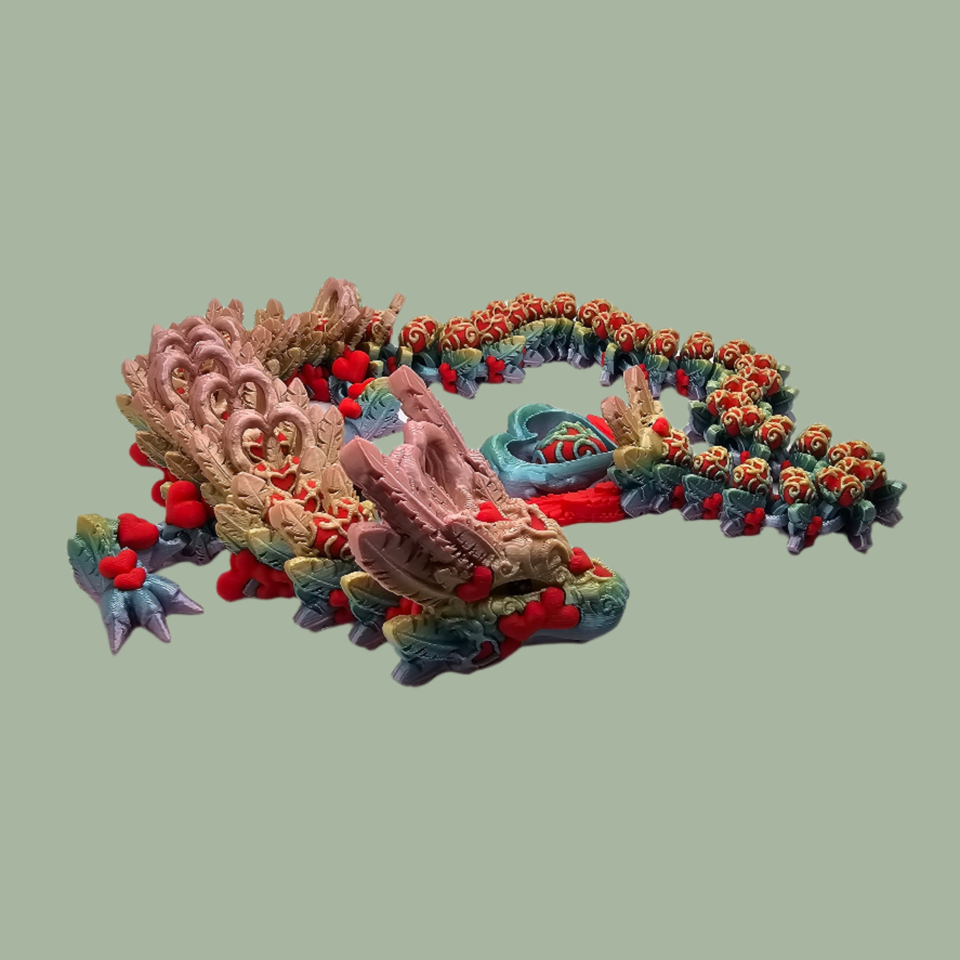 3D printed articulated dragon with heart details along the body and a spinning heart in the tail