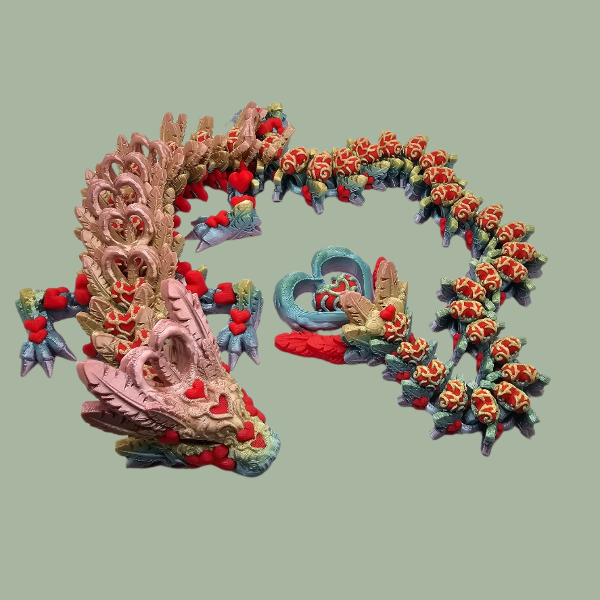 3D printed articulated dragon with heart details along the body and a spinning heart in the tail