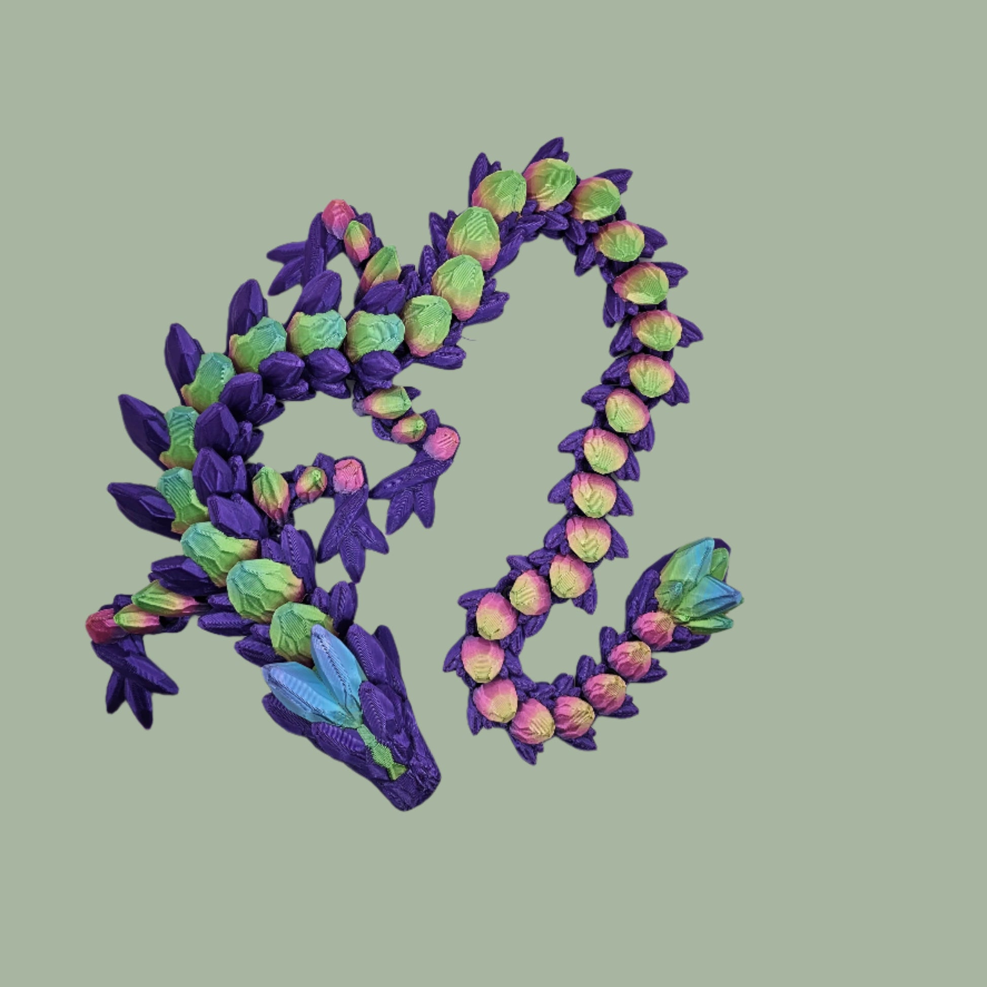 3D printed articulated dragon in a purple colour with rainbow details along the body