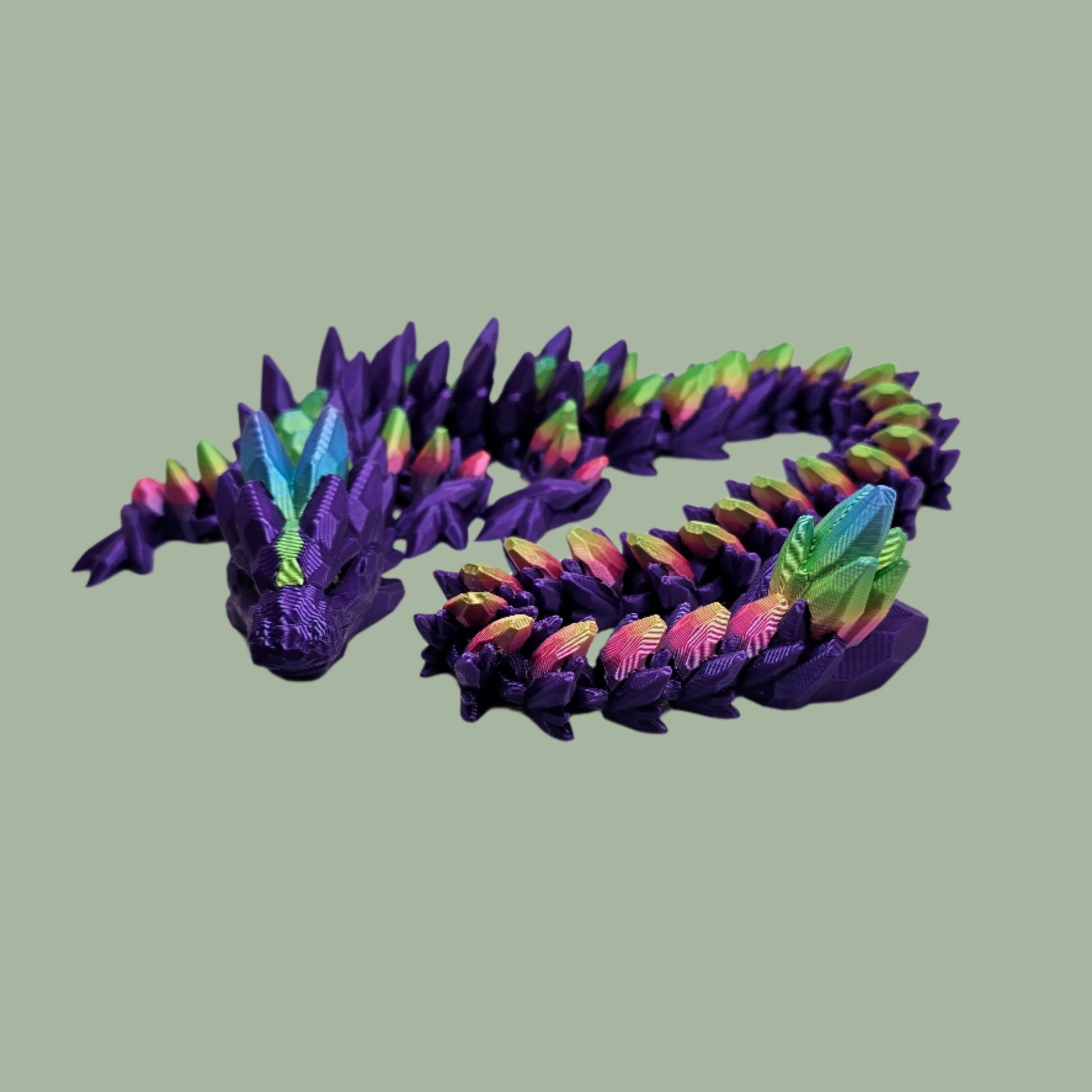 3D printed articulated dragon in a purple colour with rainbow details along the body