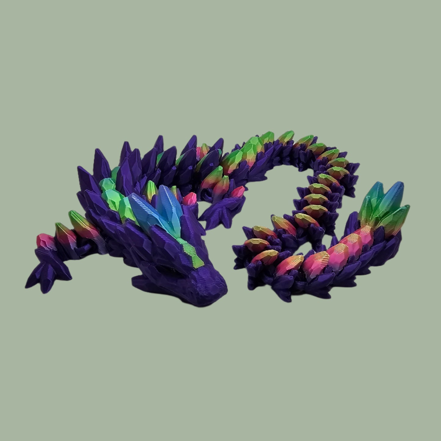 3D printed articulated dragon in a purple colour with rainbow details along the body