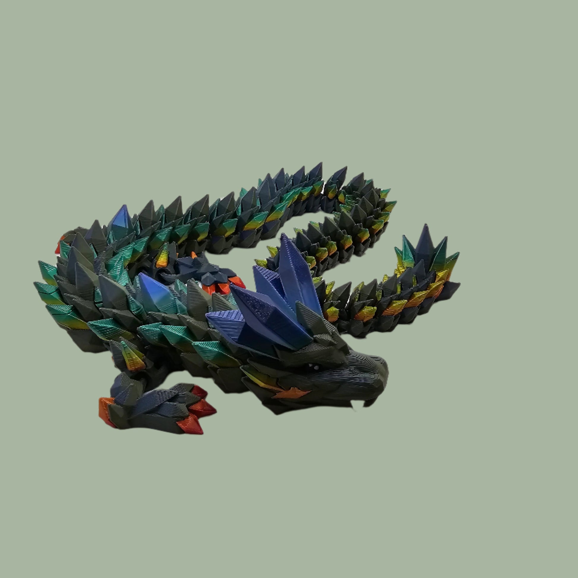 3D printed crystal style dragon in green with rainbow detail along the body