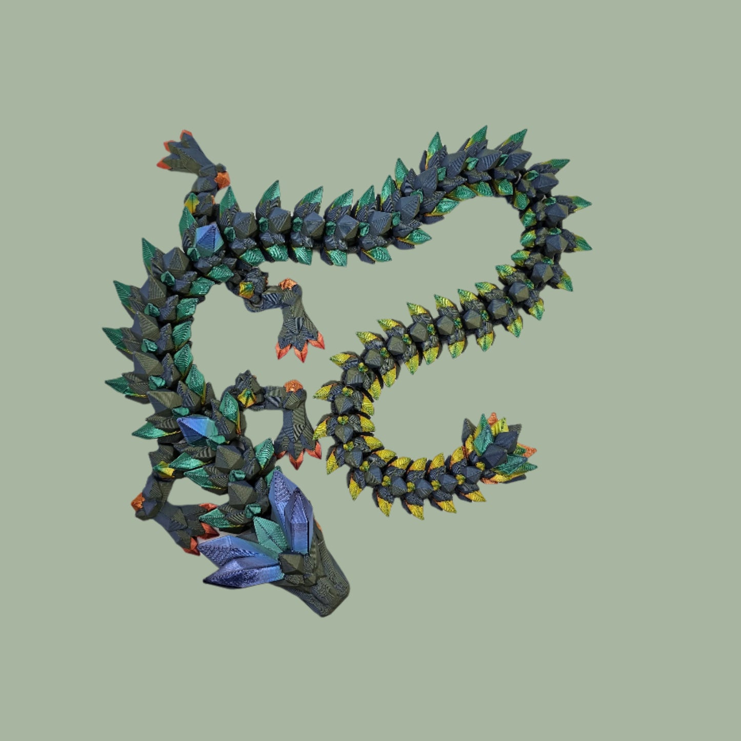 3D printed crystal style dragon in green with rainbow detail along the body