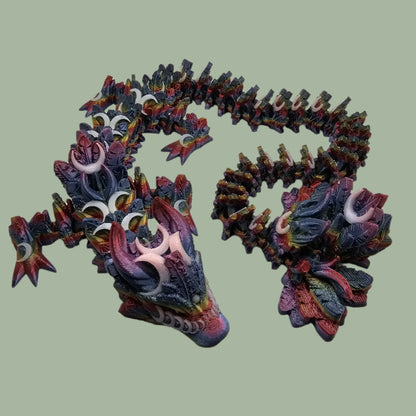 3D printed articulated dragon with crescent moon details, in a dark rainbow colour with glow in the dark moons