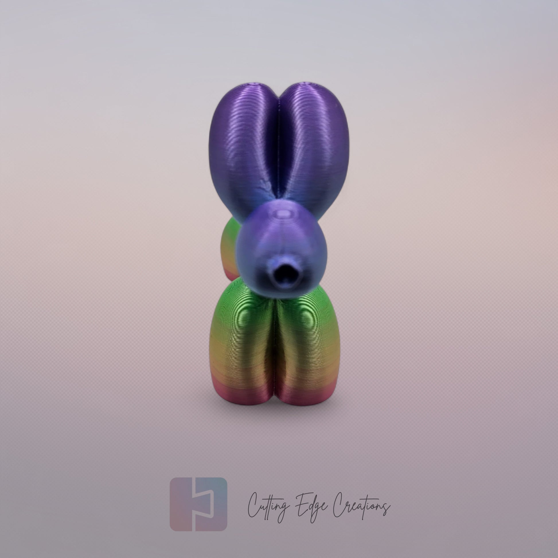 Unique rainbow balloon dog figurine, 3D printed with a smooth, glossy finish. A colourful and fun sculpture for home or office decor