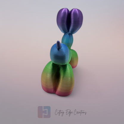 Unique rainbow balloon dog figurine, 3D printed with a smooth, glossy finish. A colourful and fun sculpture for home or office decor