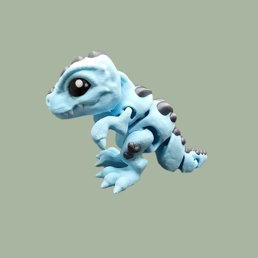 3D printed Love O’Saurus Rex dinosaur toy in light blue with black heart-shaped markings, designed as a flexible and posable fidget toy. Made in the UK by Cutting Edge Creations