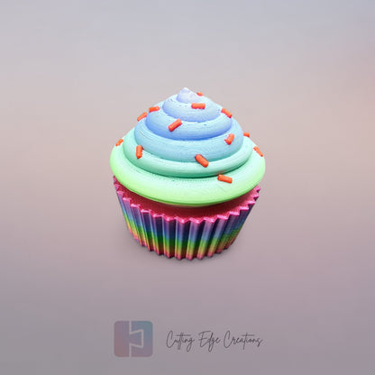 3D-printed Large Rainbow Cupcake Clicker fidget toy in vibrant rainbow colours with a built-in clicking mechanism. A fun, sensory stress relief toy, perfect for kids and adults. Handmade in the UK, 6cm wide and 5.5cm tall. Ideal for fidgeting, focus, and anxiety relief