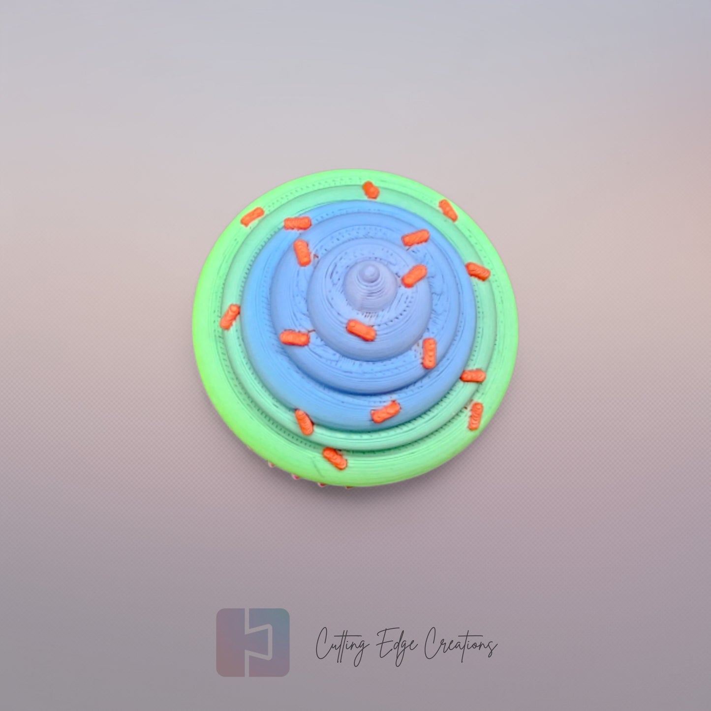 3D-printed Large Rainbow Cupcake Clicker fidget toy in vibrant rainbow colours with a built-in clicking mechanism. A fun, sensory stress relief toy, perfect for kids and adults. Handmade in the UK, 6cm wide and 5.5cm tall. Ideal for fidgeting, focus, and anxiety relief