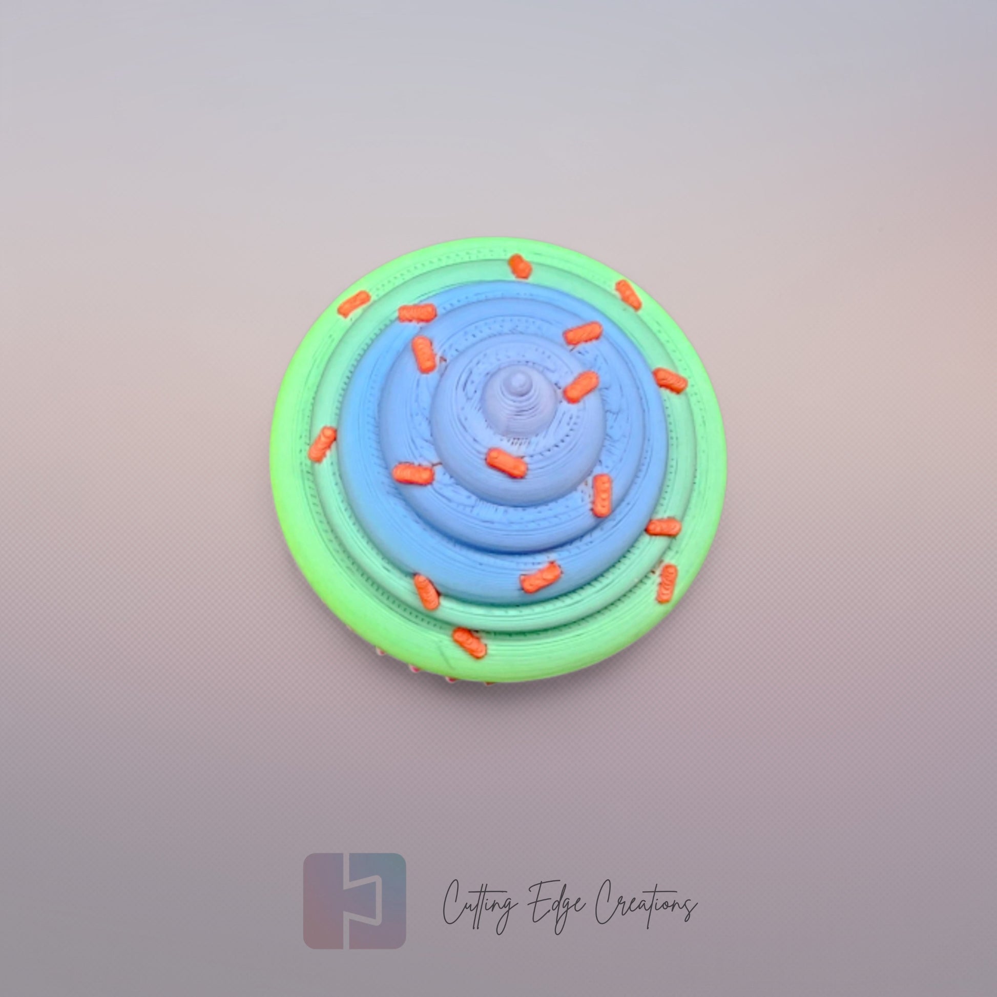 3D-printed Large Rainbow Cupcake Clicker fidget toy in vibrant rainbow colours with a built-in clicking mechanism. A fun, sensory stress relief toy, perfect for kids and adults. Handmade in the UK, 6cm wide and 5.5cm tall. Ideal for fidgeting, focus, and anxiety relief