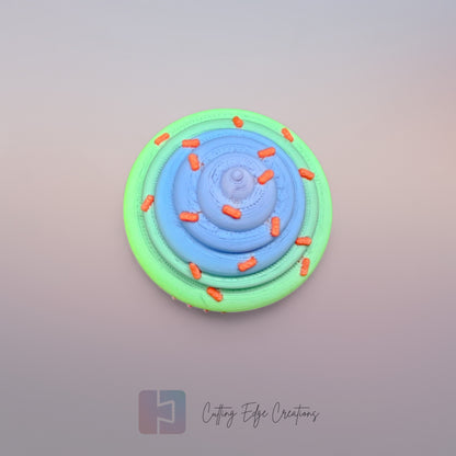 3D-printed Large Rainbow Cupcake Clicker fidget toy in vibrant rainbow colours with a built-in clicking mechanism. A fun, sensory stress relief toy, perfect for kids and adults. Handmade in the UK, 6cm wide and 5.5cm tall. Ideal for fidgeting, focus, and anxiety relief