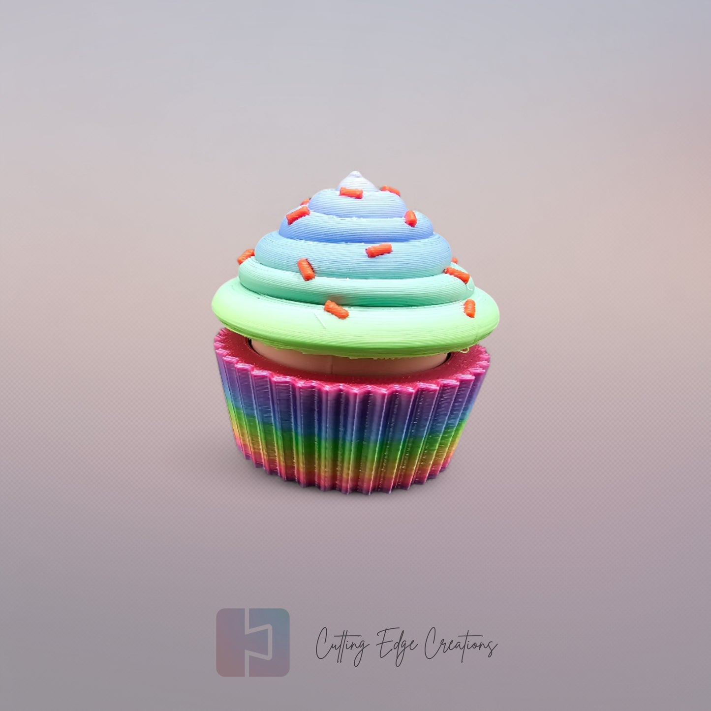 3D-printed Large Rainbow Cupcake Clicker fidget toy in vibrant rainbow colours with a built-in clicking mechanism. A fun, sensory stress relief toy, perfect for kids and adults. Handmade in the UK, 6cm wide and 5.5cm tall. Ideal for fidgeting, focus, and anxiety relief