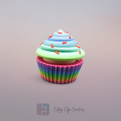 3D-printed Large Rainbow Cupcake Clicker fidget toy in vibrant rainbow colours with a built-in clicking mechanism. A fun, sensory stress relief toy, perfect for kids and adults. Handmade in the UK, 6cm wide and 5.5cm tall. Ideal for fidgeting, focus, and anxiety relief