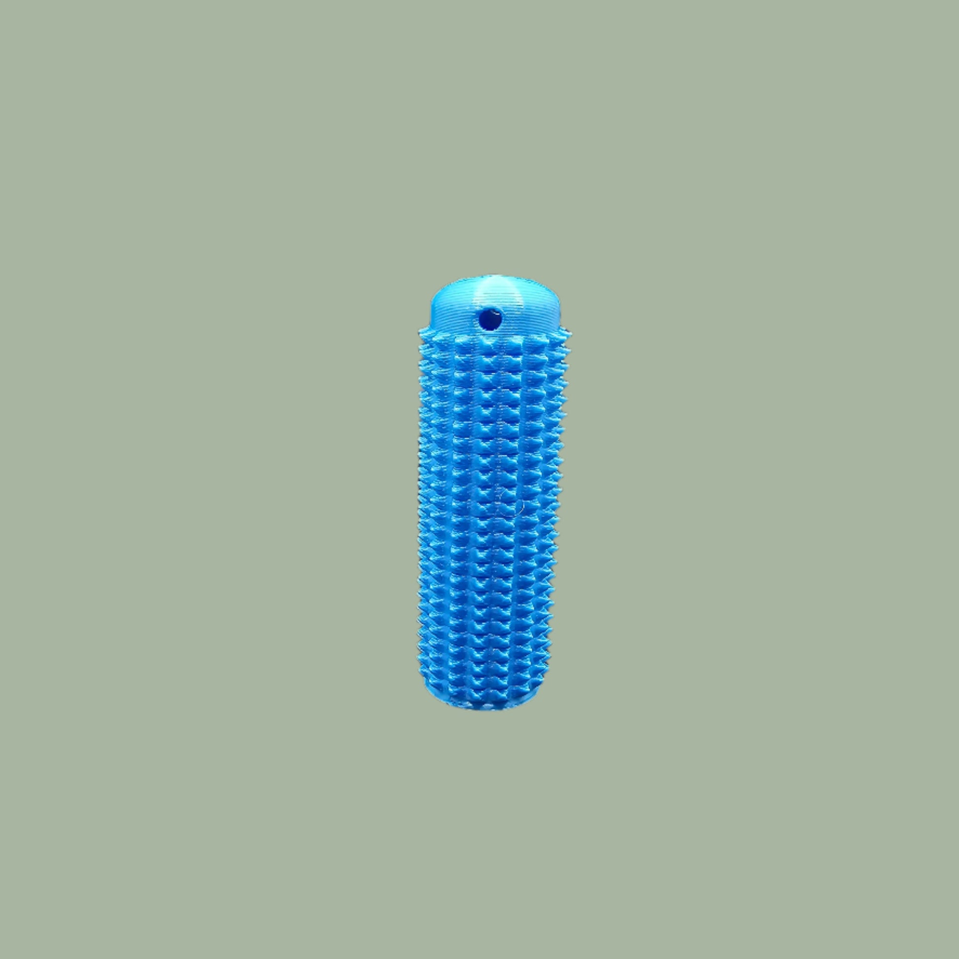 Mini Ouchie Pain Stim – a 7cm long, 3D-printed sensory tool with textured spikes for tactile stimulation, displayed against a neutral background. Includes a keychain for easy portability